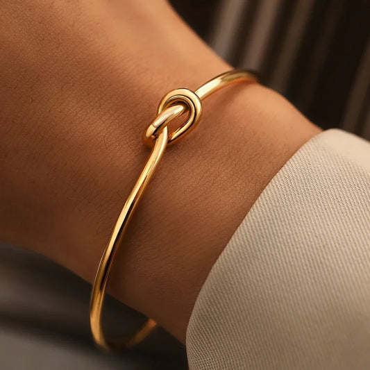 Gold Eternal Knot Bangle on a white background