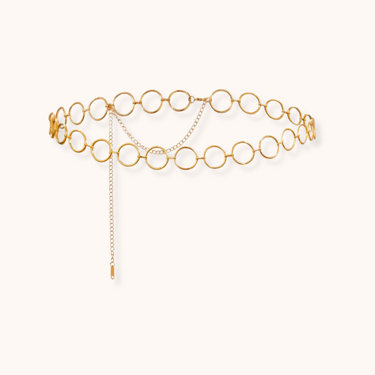 Gold circular link waist chain with drop chain detailing and adjustable clasp, made of waterproof stainless steel.
