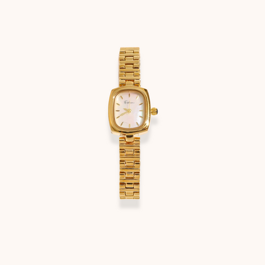Gold watch with a white face on a white background
