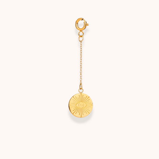 Gold sunburst medallion charm with engraved eye detail, clip-on design from Aurelia Glamour Golden Charm Collection
