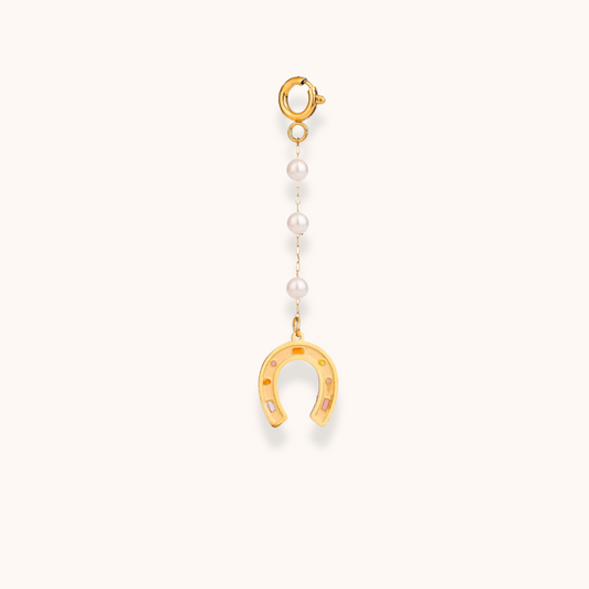 Gold horseshoe and pearl charm from the Golden Charm Collection, shown with stainless steel gold-plated clasp