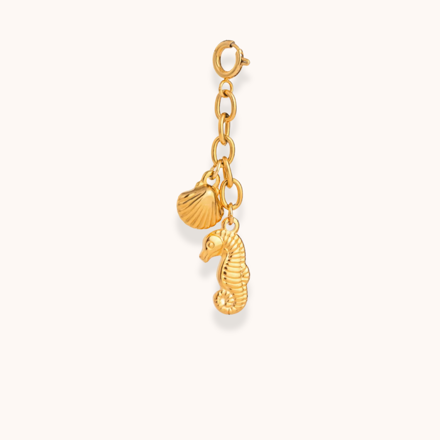 Gold seahorse and shell charm from Aurelia Glamour’s Golden Charm Collection on waterproof stainless steel chain