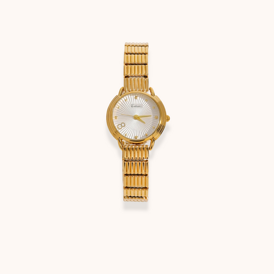 Gold watch with a white face on a white background